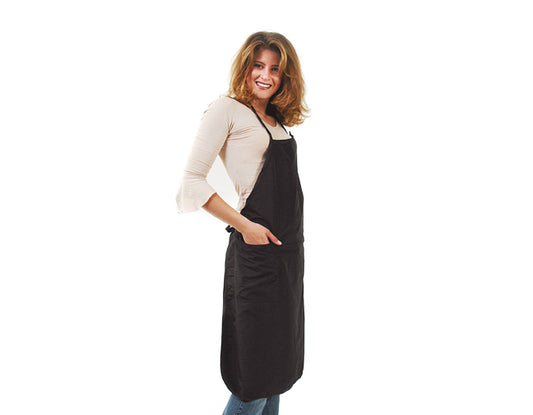 Woman wearing a black apron for hair styling at a salon